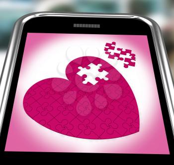 Puzzle Heart On Smartphone Showing Commitment And Engagement