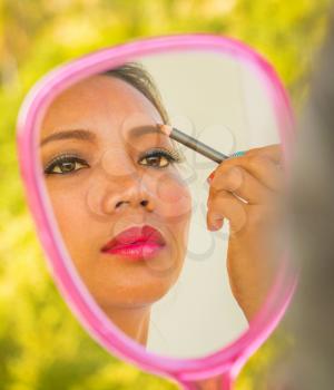 Applying Eyebrows Makeup In Mirror Showing Cosmetics