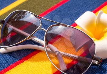 Sunglasses On Towel Showing Sunny Exotic Holiday