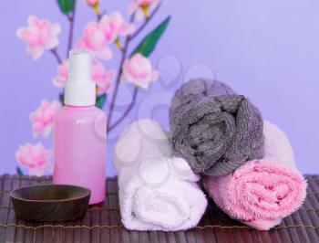 Spa Objects Including Towels Oil and Flowers
