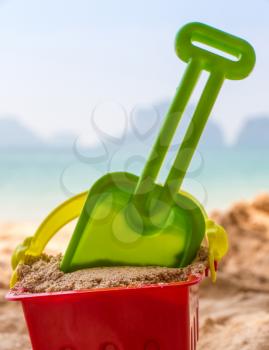Bucket And Spade On A Sandy Beach Shows Summer Vacation