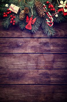 Christmas fir tree with decoration on dark wooden background
