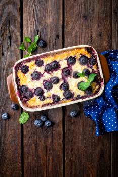 Blueberry cheesecake on dark wooden rustic backgroud, top view