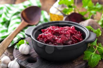 Beetroot salad on wooden background closeup