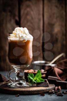 Iced cocoa drink with whipped cream, cold chocolate beverage, coffee frappe on dark background