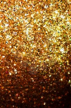 Golden glitter texture on black background. Round shimmer glowing particles. Golden glitter explosion effect. Shiny sparkles confetti.  Banner, poster, greeting card design shining vector backdrop