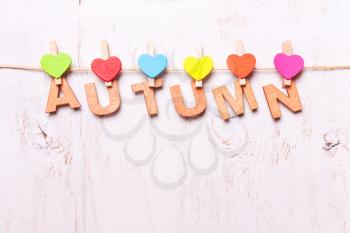 the word autumn from the wooden letters on a white background old