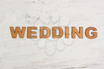 word wedding wooden letters on a white background old wooden