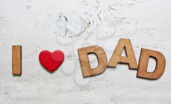 I love dad with wooden letters on an old white wooden background