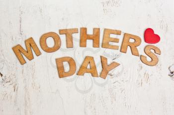  Mothers Day with wooden letters on an old white wooden background