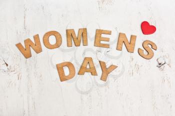 Womens Day with wooden letters on an old white wooden background