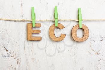 Eco word made of wooden letters on a white background old