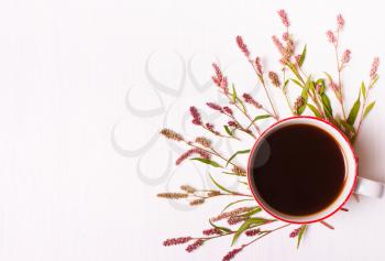 Cup of coffee with pink flowers on a white background, top view,good morning set