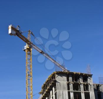 Crane  at construction site against blue sky