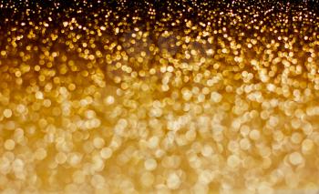 Gold defocused bokeh lights background, festive glitter