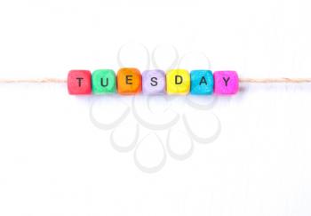 Tuesday word of multicolored cubes on a white background