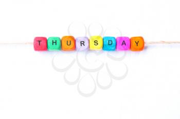 Thursday word of multicolored cubes on a white background