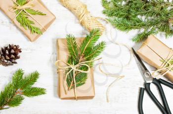 Decoration of the tree branches, cones, gifts on wooden background