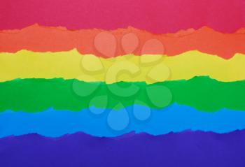 Rainbow flag made of paper, LGBT symbol, colorful background