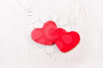 two red wooden heart on a white background