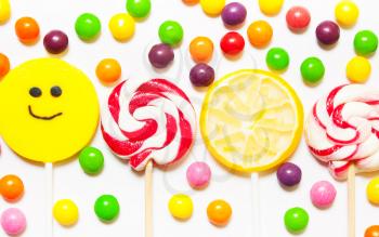 Lollipops, candy smile on, scattered round pills on a white background. Top view, flat