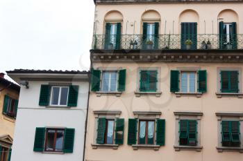 Old Italian house with green shutters and balconies and medieval architecture