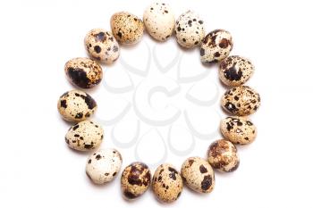 A round frame of quail eggs in a row on a white background. View from above, flat