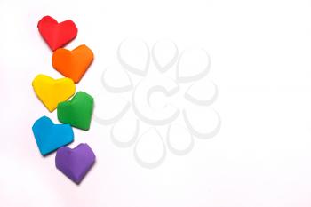 Paper hearts of a rainbow color on a white background. LGBT  symbol