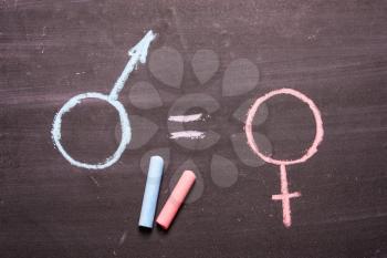 A sign, a symbol of a man and a woman, is drawn in chalk. The concept of equality, equal rights