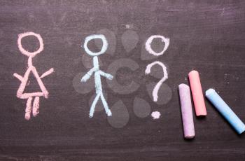  sign, a symbol of a man and a woman, is drawn in chalk. The concept of gender, transgender, sex selection