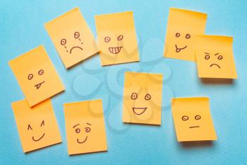 Funny stickers, notes with a smile on a blue background.Positive Attitude and Happy Concept