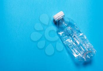 Plastic bottle on a blue background..The concept of sorting polyethylene, household waste. 