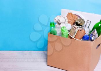 In a cardboard box plastic, glass bottles, cans, paper. The concept of separate sorting of garbage, environmental protection, ecology, recycling household waste