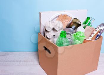 In a cardboard box plastic, glass bottles, cans, paper. The concept of separate sorting of garbage, environmental protection, ecology, recycling household waste