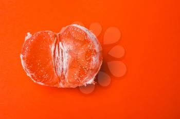 Concept sex, masturbation. Grapefruit, vagina symbol on orange background