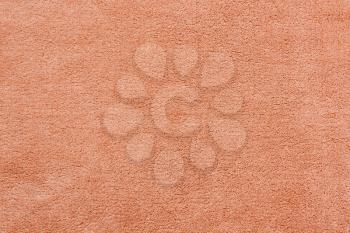 Beige soft fleece texture. The surface of a teddy crumpled microfiber rug