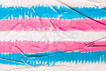 Concrete, the wall of the transgender flag color in the hands. Pink, white, blue background.