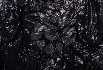 Black plastic bag. The concept of using environmentally friendly packaging, processing and sorting, preservation of the environment