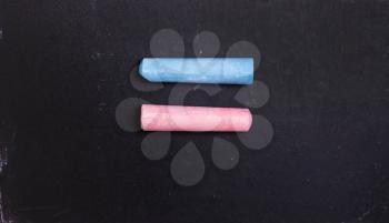 Blue and pink chalk on a blackboard, symbol of equality of women and men. Feminism