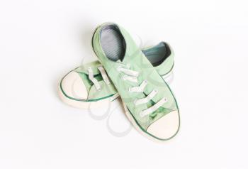 Vintage old green sneakers, shoes. Concept of multiple trips, free life, tourism