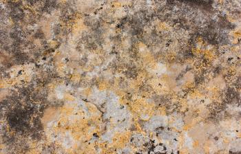 Old stone grunge gray yellow orange texture with lichen