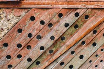 Grunge, wooden, ancient texture. Old background with wavy paint, orange paint and round holes