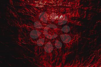 Dark red  Halloween hellish grunge abstract crumpled aluminum, titanium shiny foil background