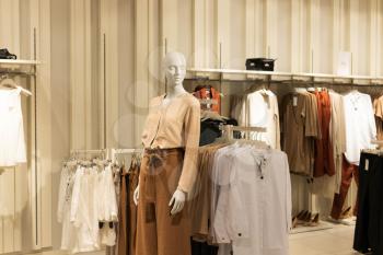 Women's clothes, fashionable, stylish on hangers in stores. Shopping Concept, Sales.Pastel beige colors