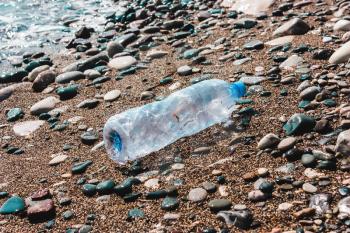 Used plastic bottle in water. Concept of pollution of the environment, ocean, sea, nature. Save the planet..zero waste