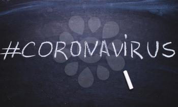 Coronavirus hashtag on chalk board. Epidemic concept