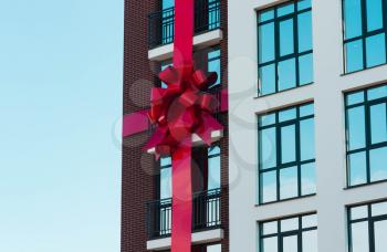 The concept of buying an apartment, buy, get it, on credit. A house with a bow, a gift