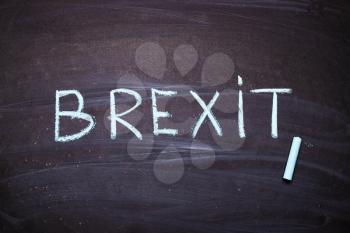 The word Brexit is written in chalk on a blackboard.EU and UK politics