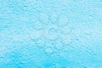 detergent foam, shampoo on blue background. The concept of cleanliness, cleaning