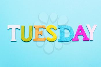 Word tuesday in multicolored letters on a blue background